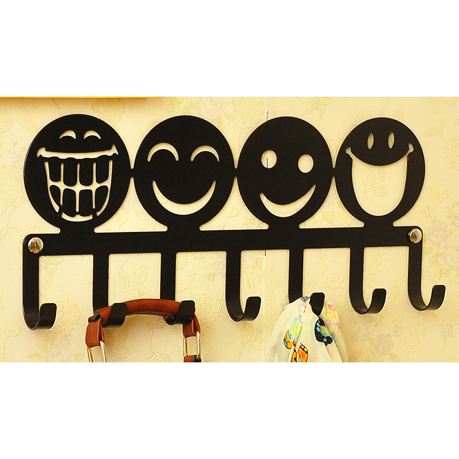 Black wall metal coat rack with with 7 hangers and smiling face