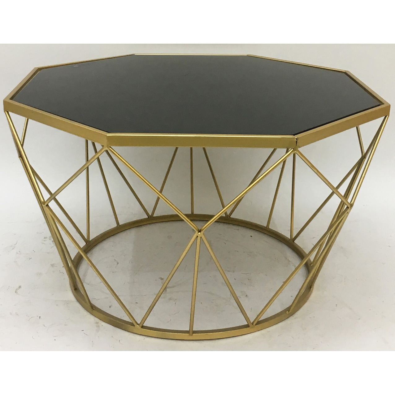 Gold octagonal metal coffee table with clear glass top and X metal side