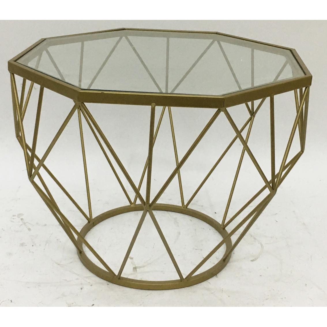 Gold octagonal metal coffee table with clear glass top and X metal side