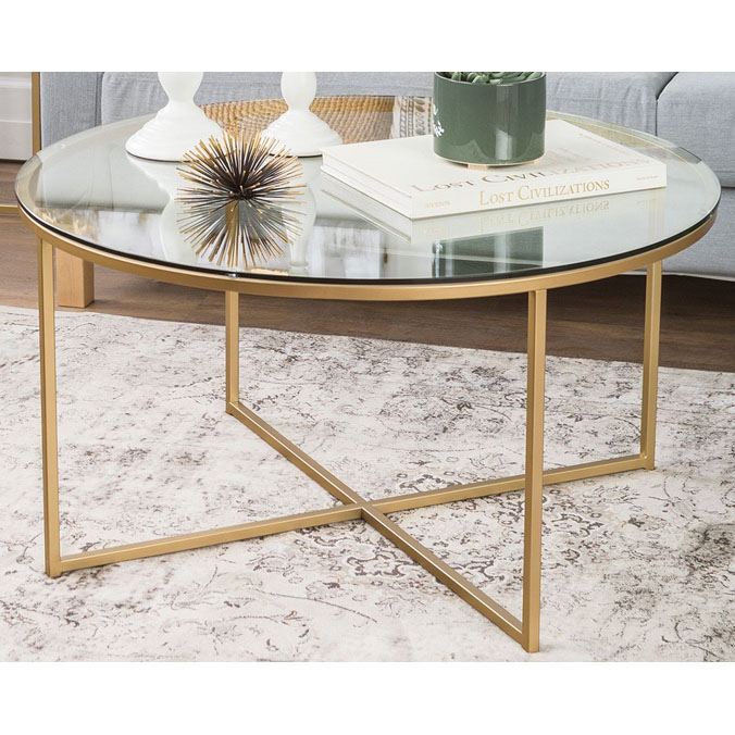 Gold metal coffee table with round clear glass top